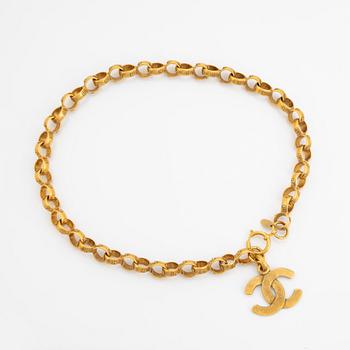 Chanel, a gold tone chain/belt.