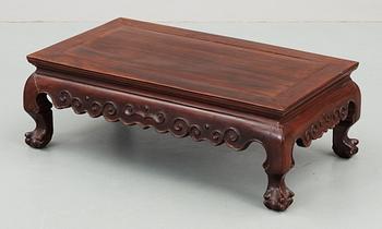 A hardwood 'claw on ball' low table, Qing dynasty.