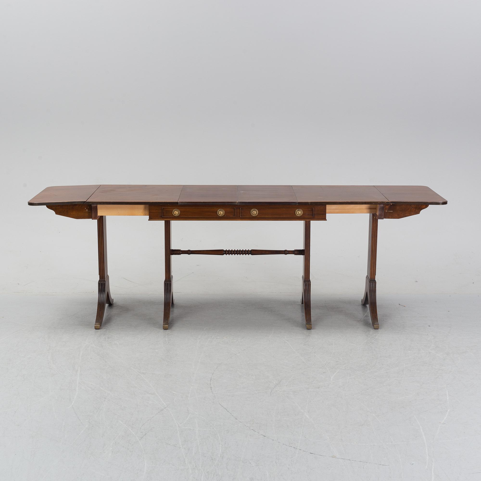 A mahogany dining table with folding and additional leaves, Nordiska Kompaniet, designed 1945.