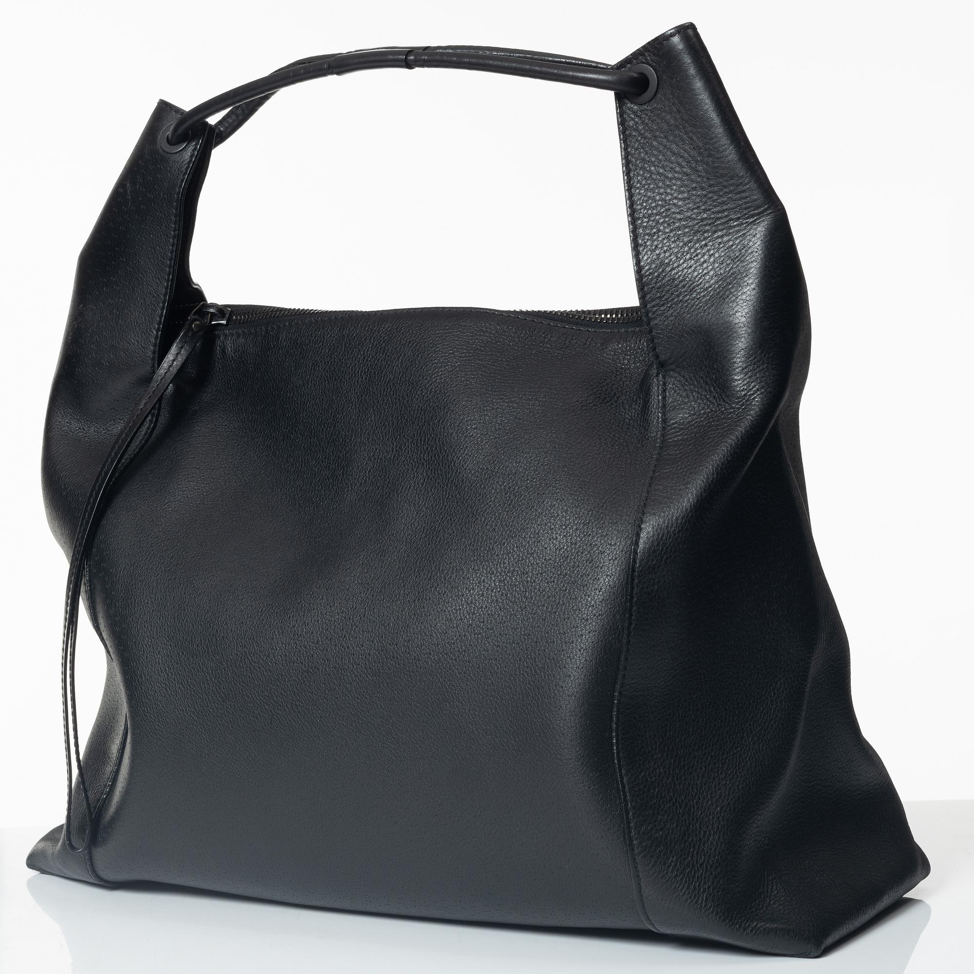 Gucci, A black leather hobo bag.