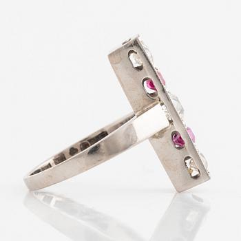 An 18K white gold ring set with faceted rubies and old-cut diamonds.