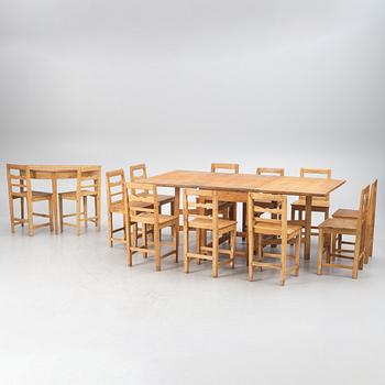 A gateleg table eith 6 + 6 chairs.