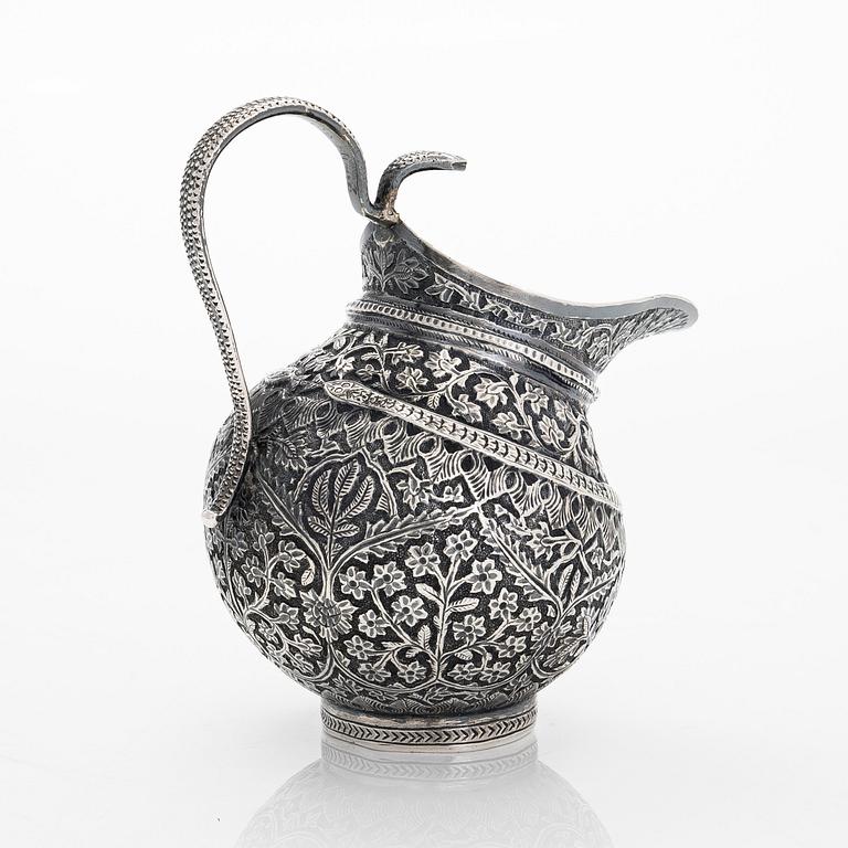 An Indian silver cream jug, and a filigree silver dish, presumably first half of the 20th century.