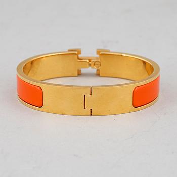 HERMÈS, a 'Clic H' bangle.