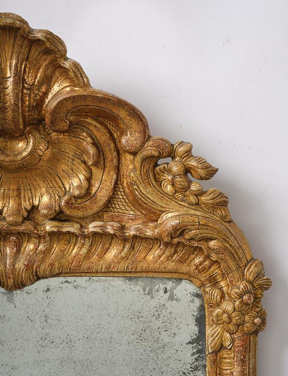 A two-branch giltwood rococo girandole mirror, Stockholm, later part 18th century.
