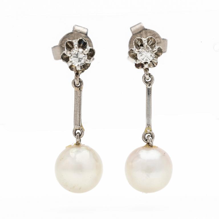 18K white gold earrings with cultured pearls and diamonds.