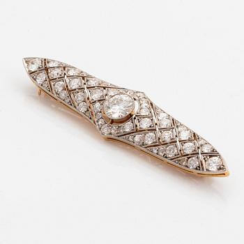 A platinum and 14K gold brooch set with an old-cut diamond weight ca 1.05 cts quality ca H si.