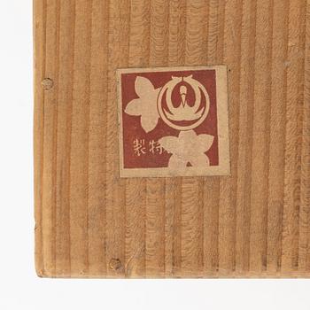 A Japanese wooden box with 15 small dolls, 20th Century.