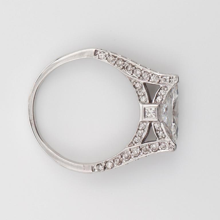 A marquise-cut diamond, circa 0.85 ct, and brilliant-cut and princess-cut diamonds, circa 0.75 ct in total, ring.