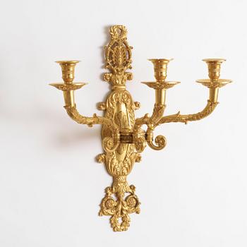 A pair of Empire-style late 19th century gilt bronze three-light wall-lights.