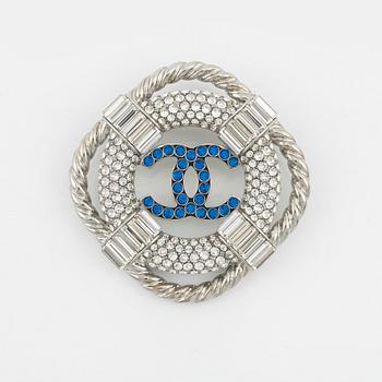 Chanel, a silvermetal, rhinestone and crystal brooch, 2019.