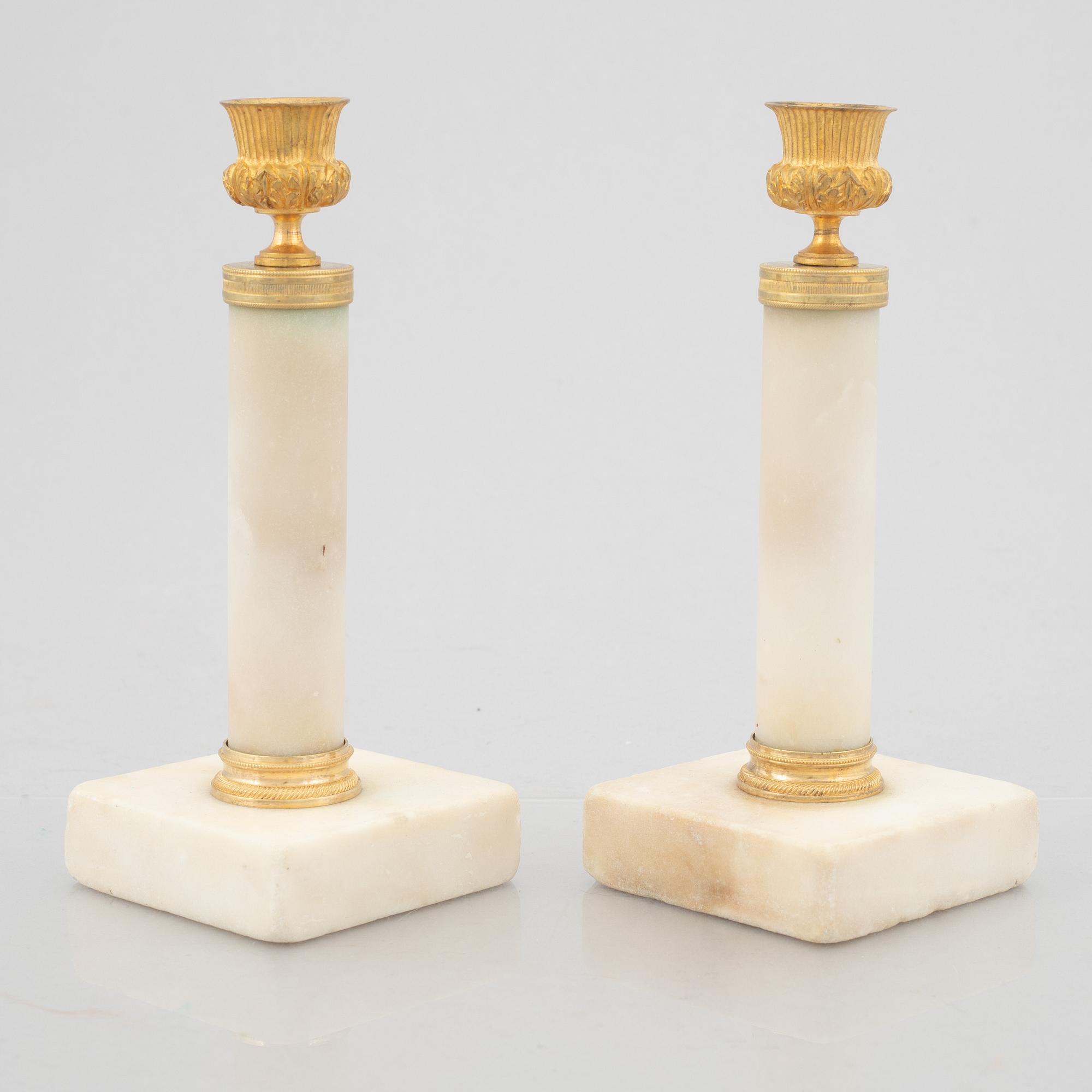 A pair of marble and gilt-bronze Louis XVI-style candelsticks, circa 1900.