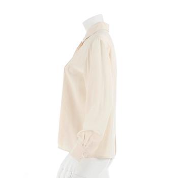 CÉLINE, a créme colored silk blouse.