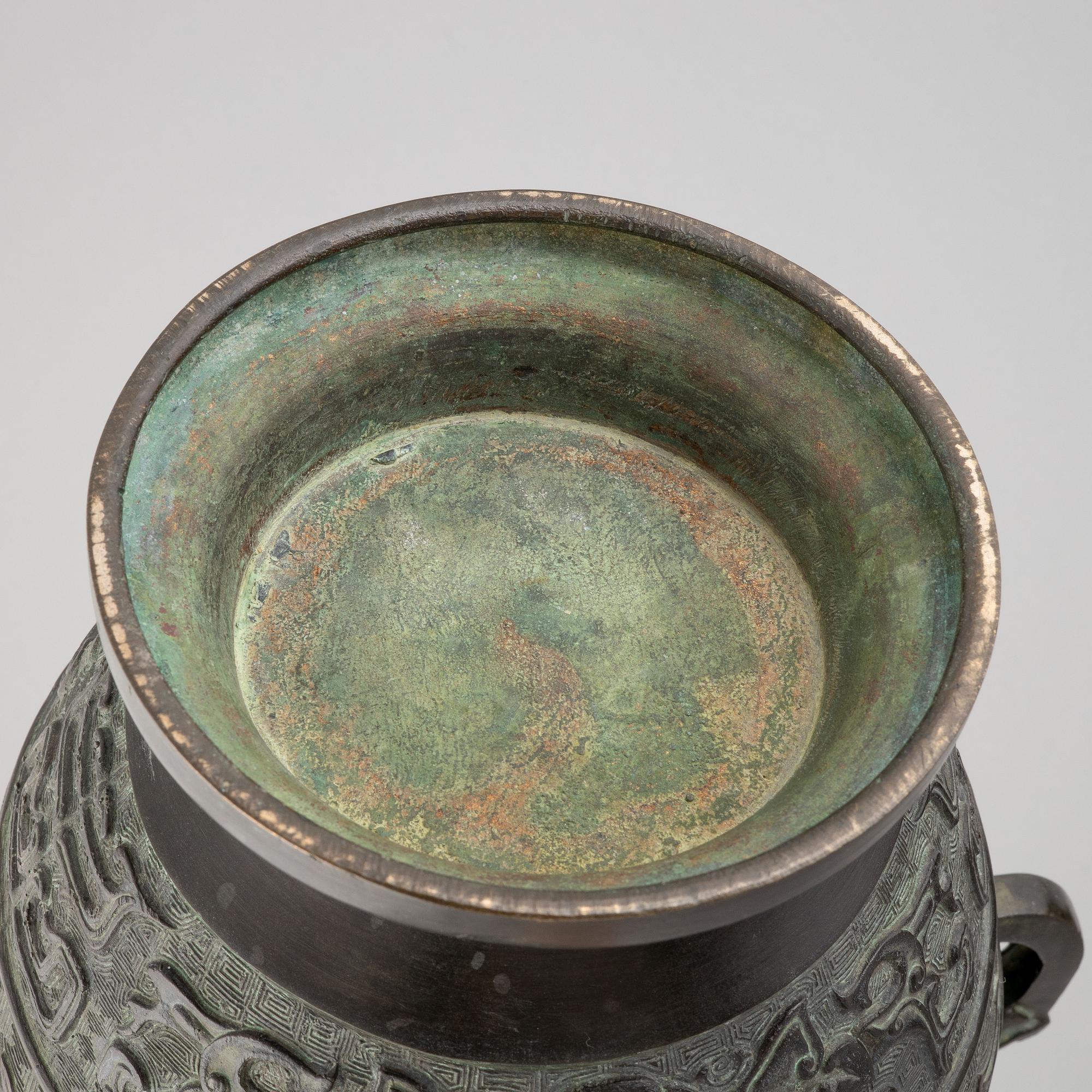 A pair of Chinese bronze urns, 20th century.