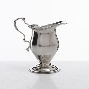 A silver cream jug, mark of S W Smith & Co, Birmingham, England 1929.