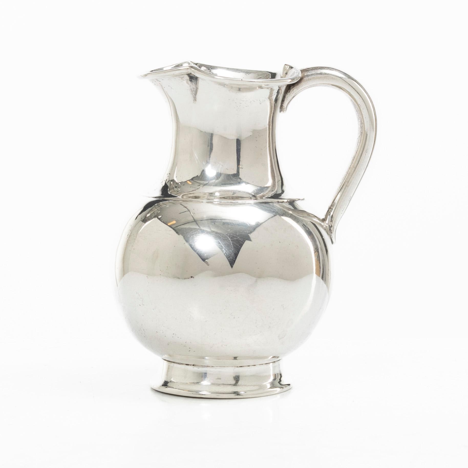 A British silver creamer, mark of Henry John Lias & Son, London 1875.
