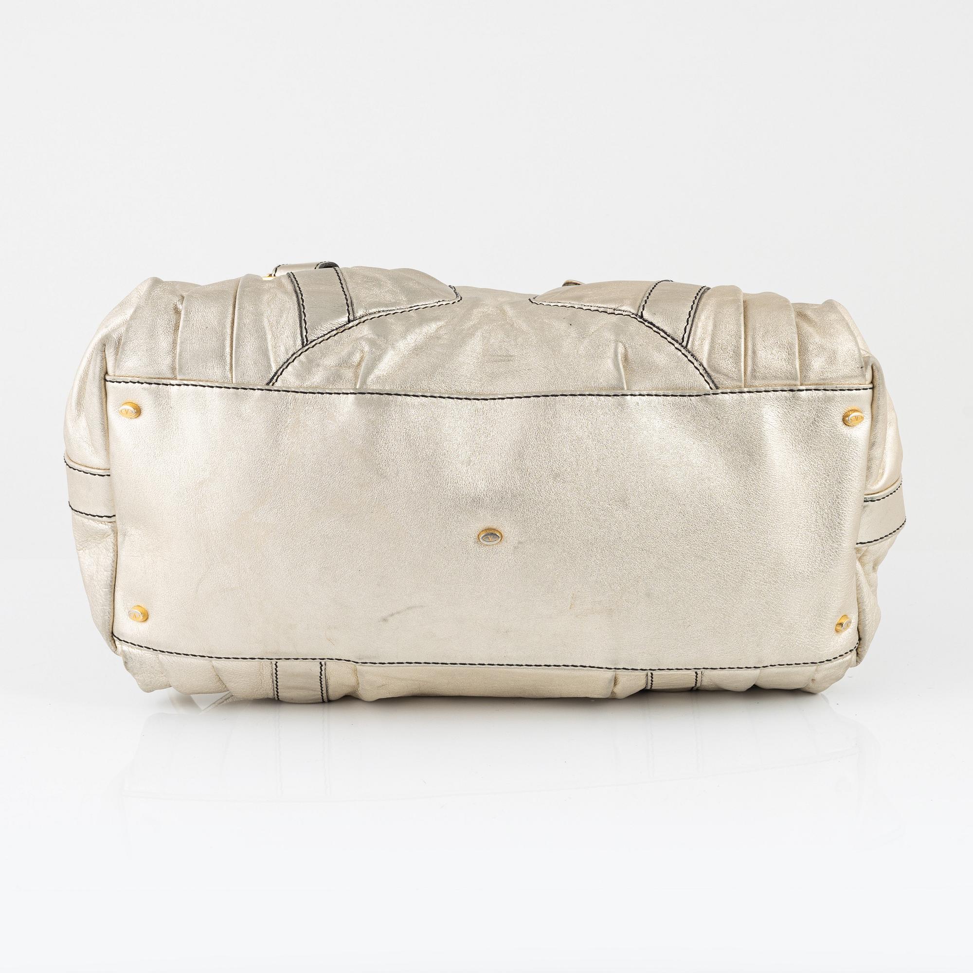 Valentino Garavani, A metallic leather bag.
