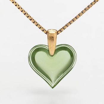 A Lalique heart pendant with an 18K gold chain.