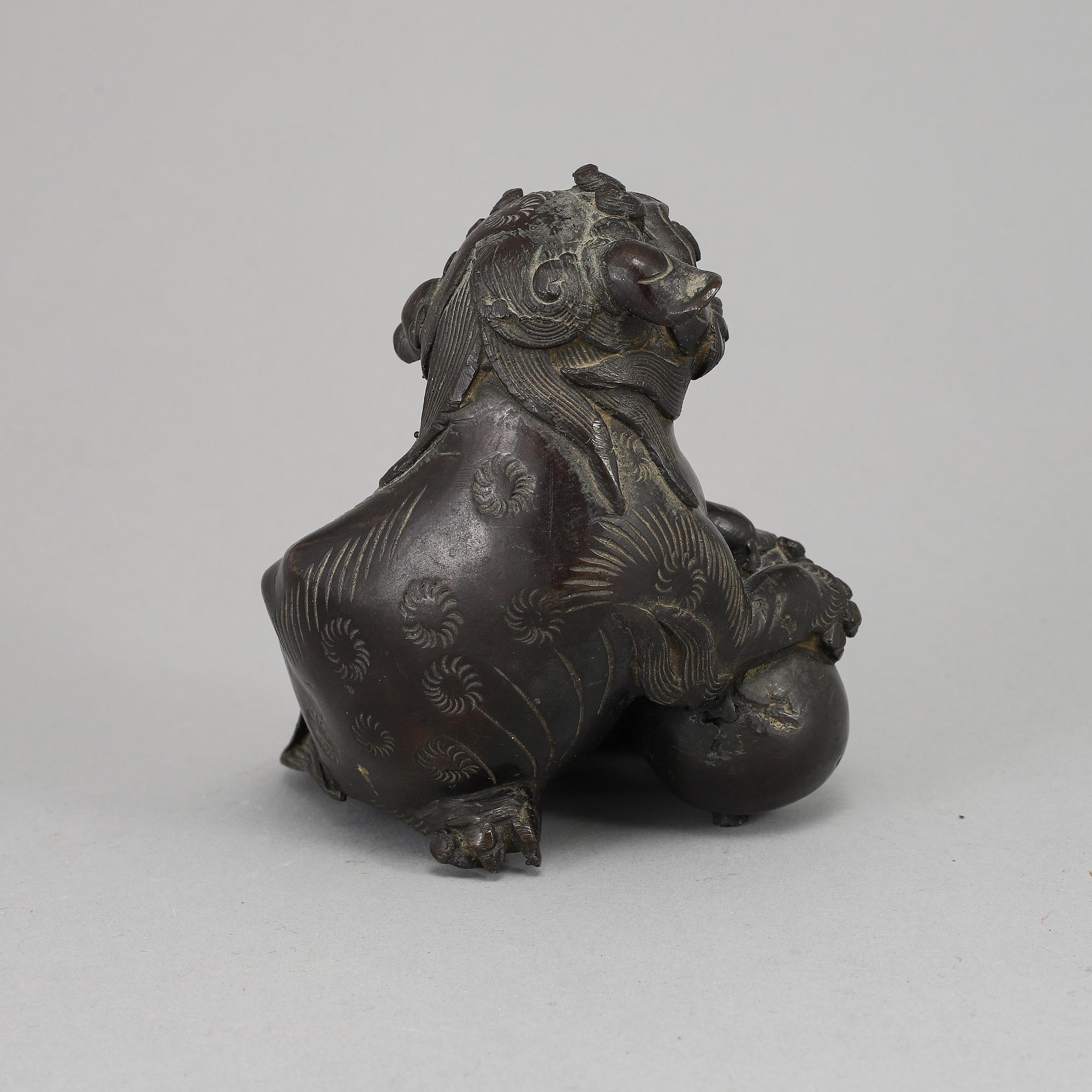 A bronze figure of a buddhist lion, Qing dynasty, circa 1900.