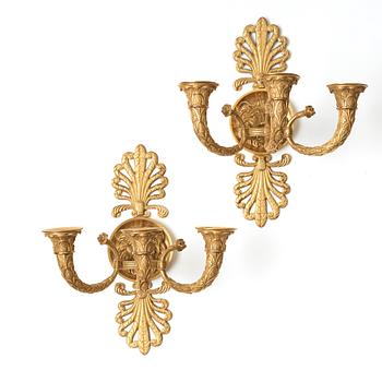 A pair of French Empire early 19th century three-light wall-lights.