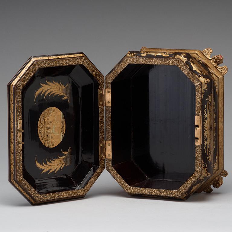 A lacquered tea box with pewter canisters, Qing dynasty, late 19th Century.