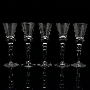 A set of five snapps glasses and a snapps bottle, with Gustav III crowned monogram. 20th century, Baroque-style.