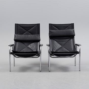 A pair of easy chairs and ottoman, designed by Hans Eichenberger, Strässle, Switzerland.