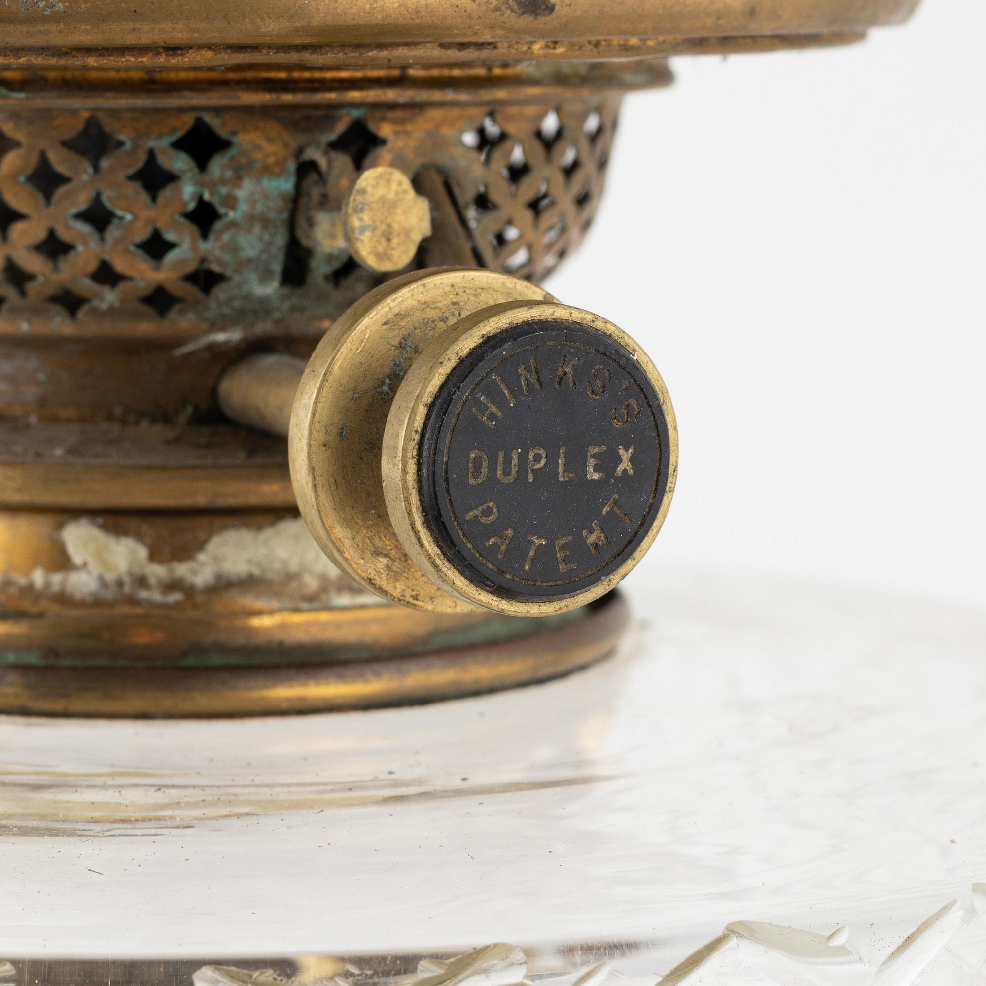 A brass and glass column shaped paraffin lamp, end of the 19th Century.