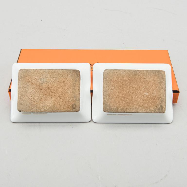 HERMÈS, a pair of porcelain ashtrays.