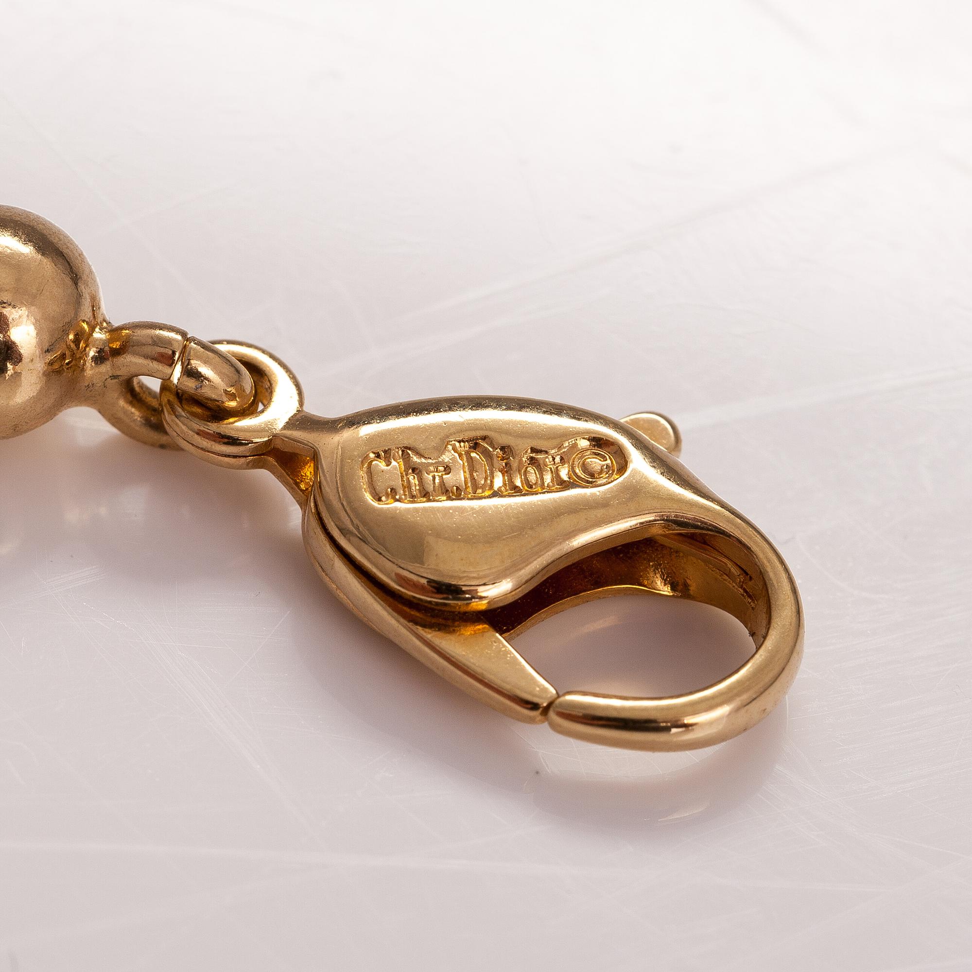 DIOR. A necklace and a pair of earrings in gold coloured metal. Marked Chr. Dior Germany. Bukowskis