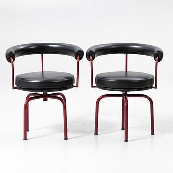 Charlotte Perriand, /Le Corbusier, swivel armchairs, a pair, model LC7, Cassina, Italy, latter half of the 20th century.