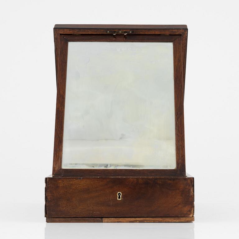 An early 19th century mahogny-veneered box for shaving utensils.