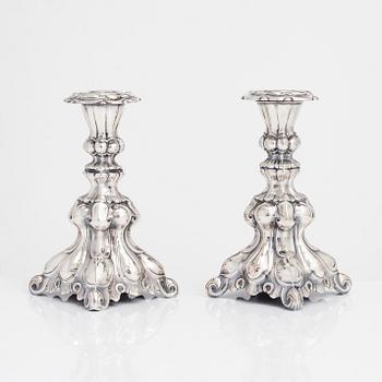 Two similar baroque style silver candlesticks by Kultakeskus, Hämeenlinna 1948 and Hopeatehdas Oy, Helsinki 1953.