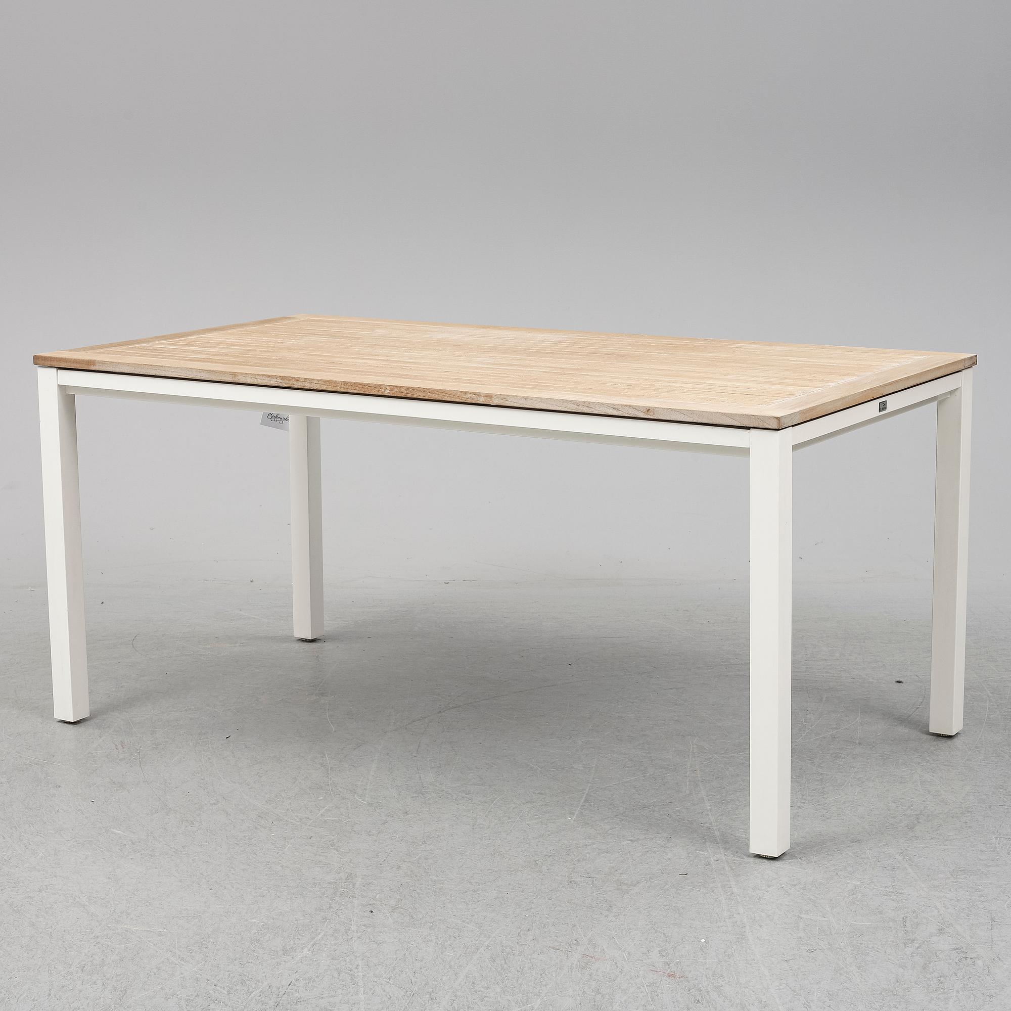 A garden table with four chairs, Gloster.