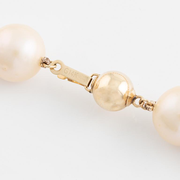 A cultured freshwater pearl necklace with 14K gold clasp.