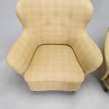 A pair of mid-20th century armchairs.