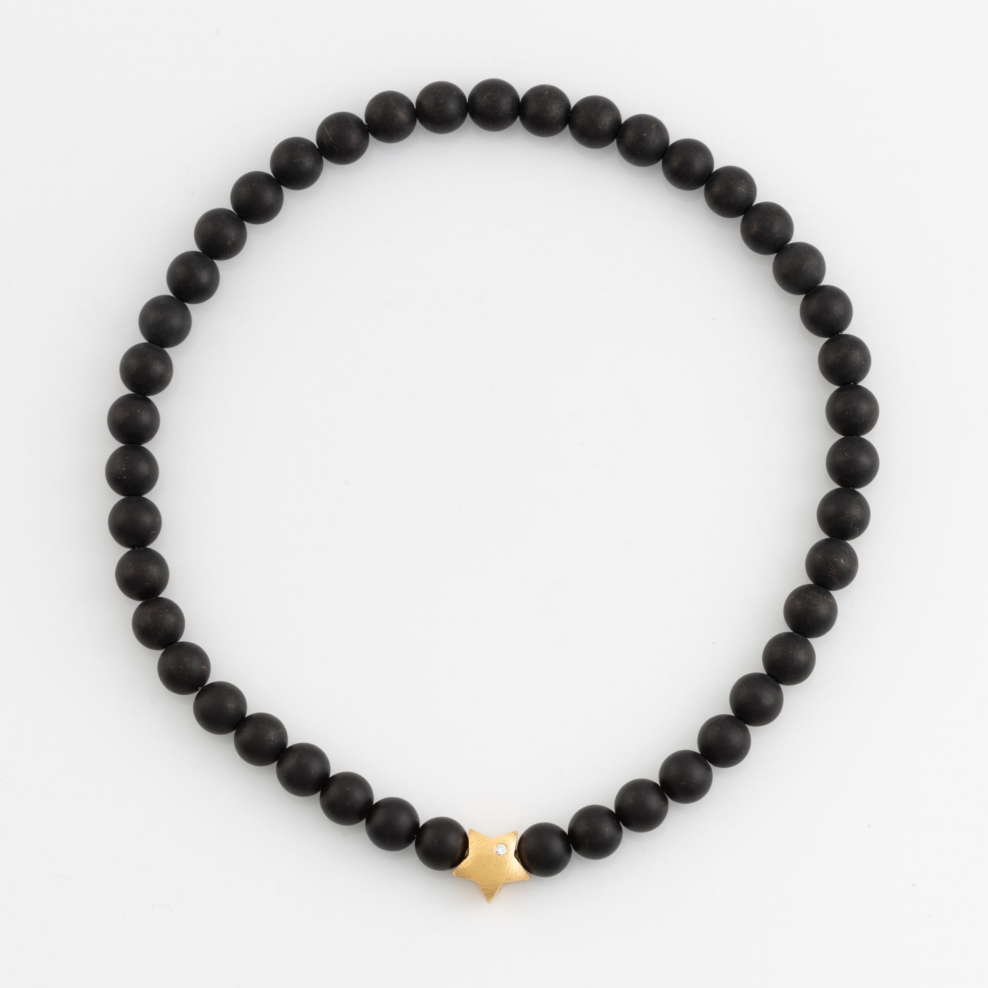 Ole Lynggaard, black stone  bead necklace, clasp star 18K gold with brilliant cut diamond.