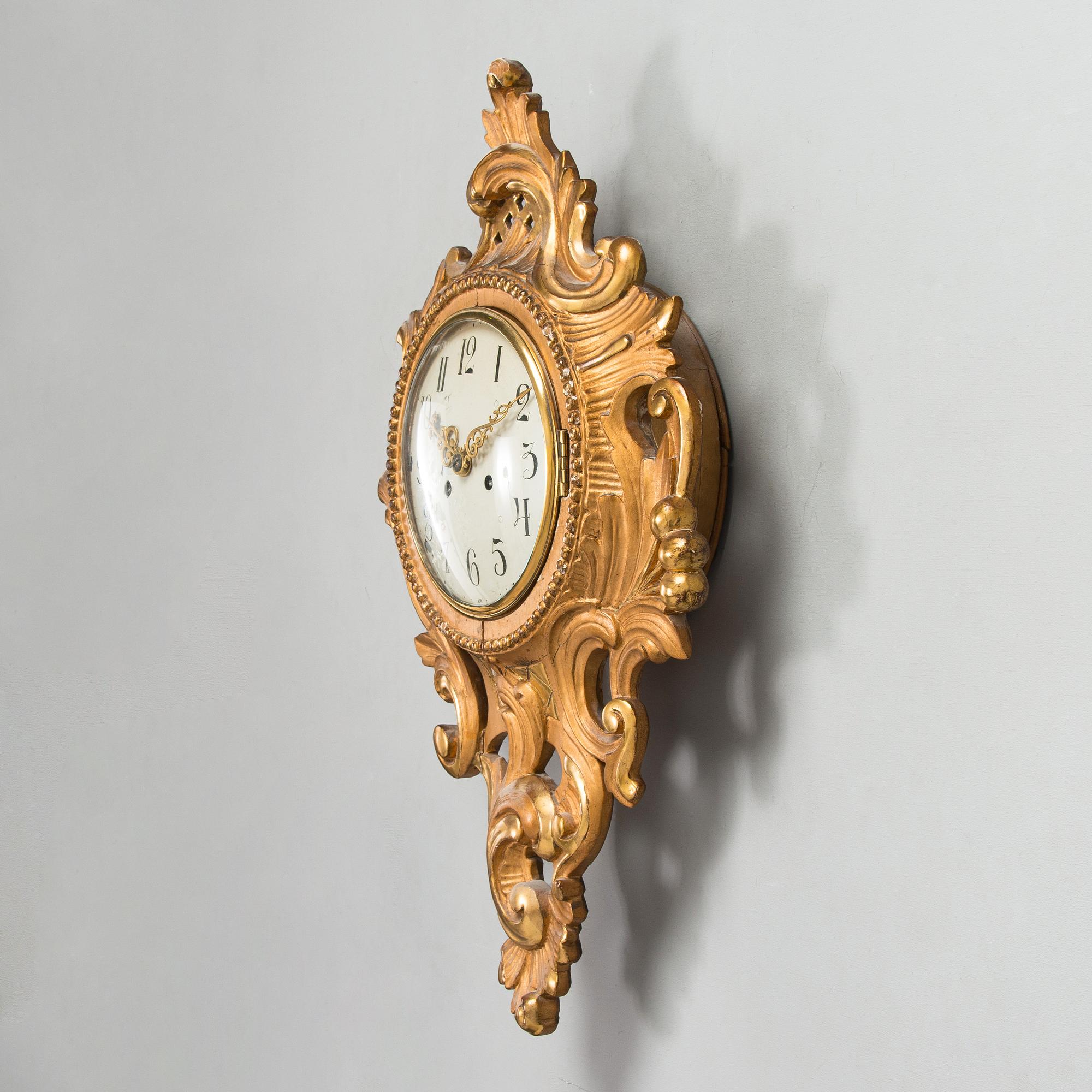 A Rococo style wall clock from first half of the 20th century.