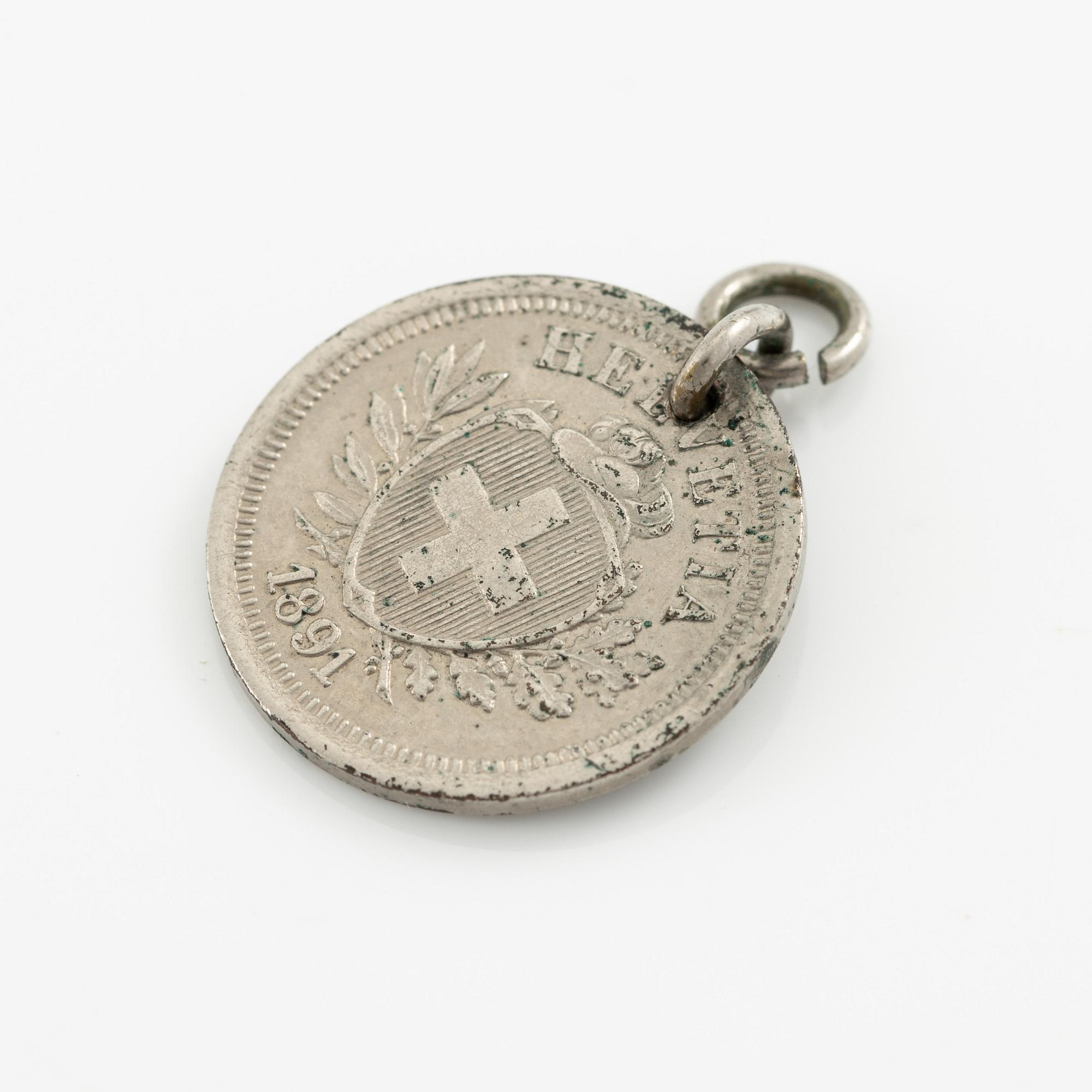 Two bracelets, a brooch, and a pendant with coins.