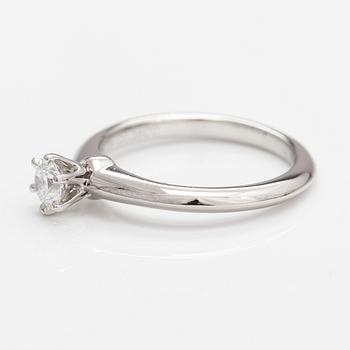 Tiffany & Co, A platinum ring with a ca. 0.26 ct diamond.