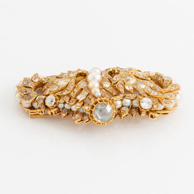 An 18K gold brooch/pendant set with old- and rose-cut diamonds and pearls.