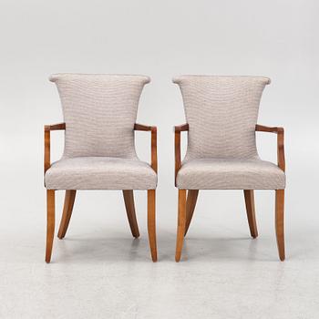 A pair of stained beech armchairs, 20th Century.