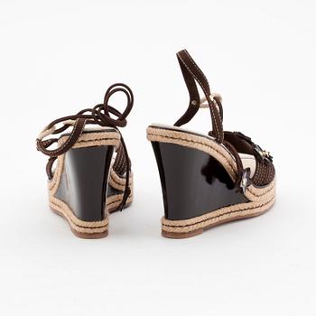 LOUIS VUITTON, a pair of straw and brown leather wedge sandals.