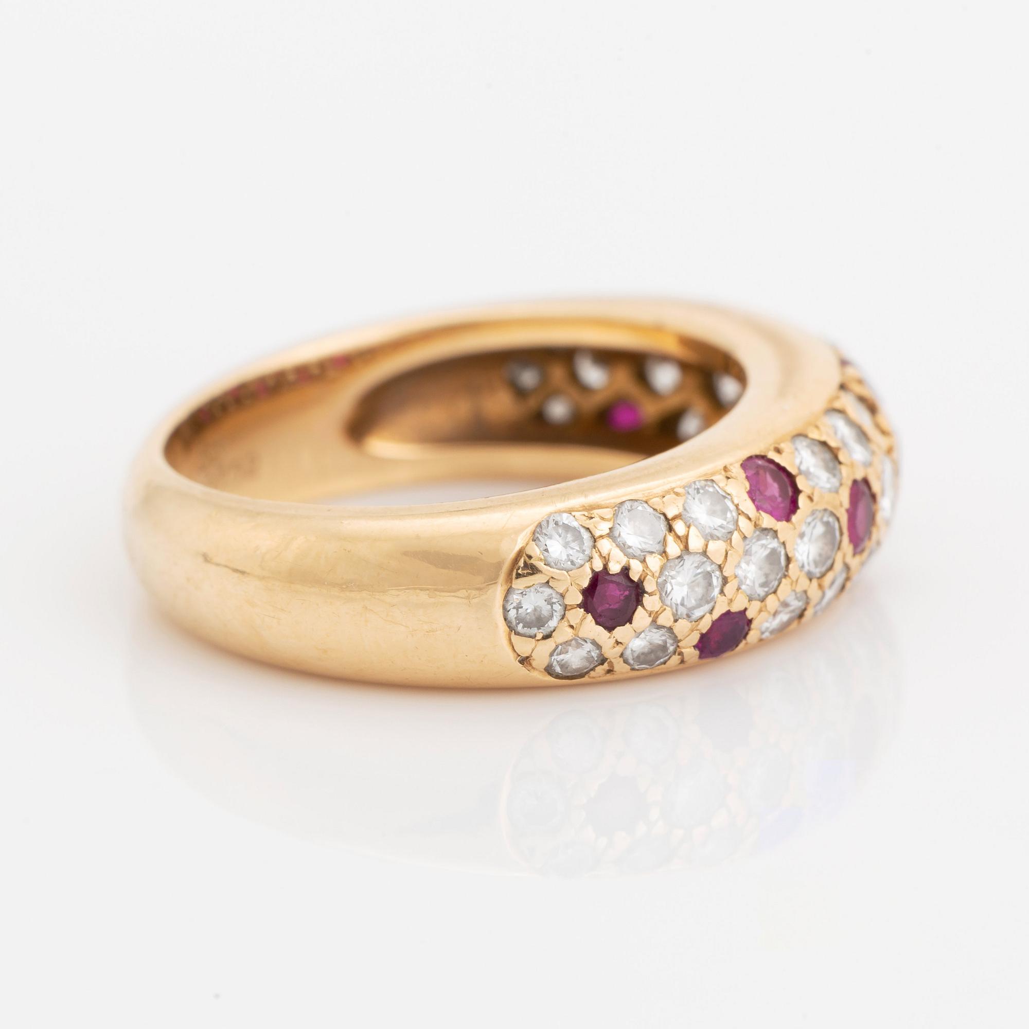An 18K gold Cartier ring set with round brilliant-cut diamonds and rubies.