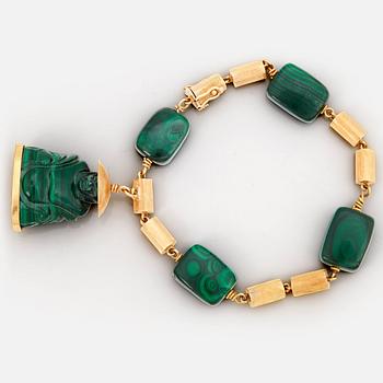 919. A malachite bracelet with a Buddha charm.