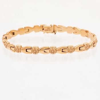 An 18K gold bracelet.