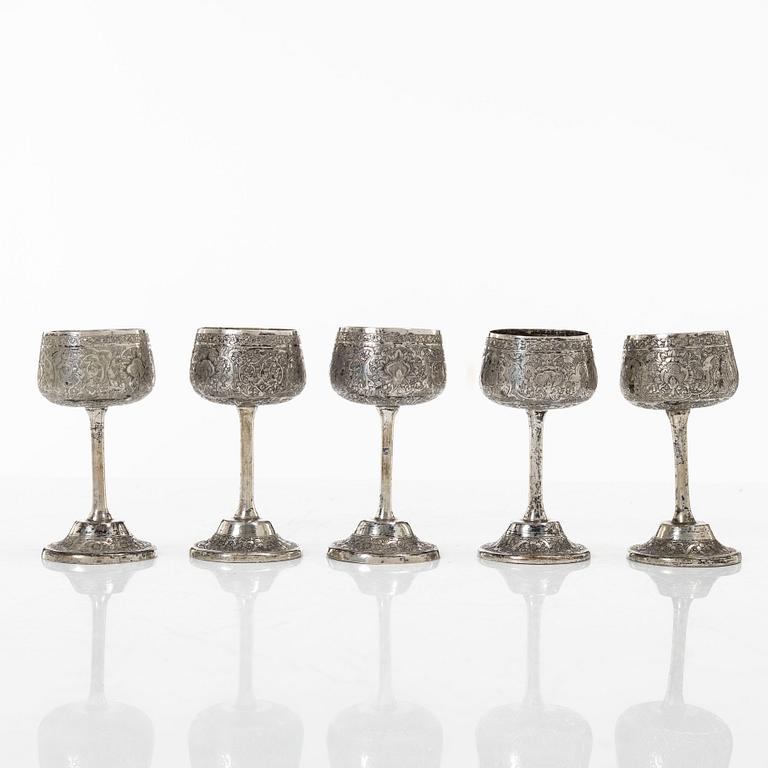 A Persian silver pitcher with five stemmed cups and a beaker, first part of the 1900s.
