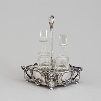 An Art Nouveau early 20th century silver cruet-set for four glass containers, unknown master.