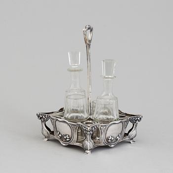 An Art Nouveau early 20th century silver cruet-set for four glass containers, unknown master.