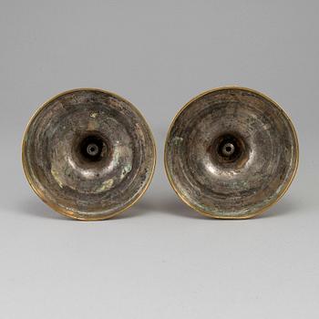 A pair of late 18th century bronze candlesticks.